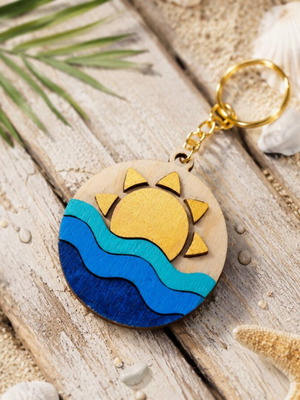 Handmade wooden summer keychain with laser cut sun and waves design