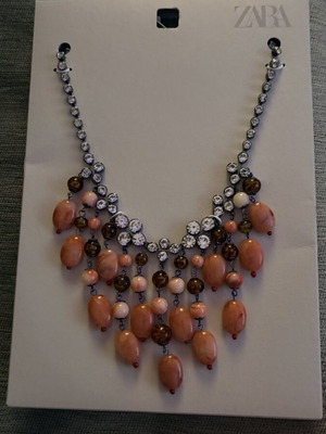Waterfall style necklace with applique jewelry and colored stones
