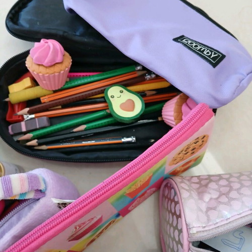 School supplies used, pencil cases, erasers, paints, notebooks, pencils