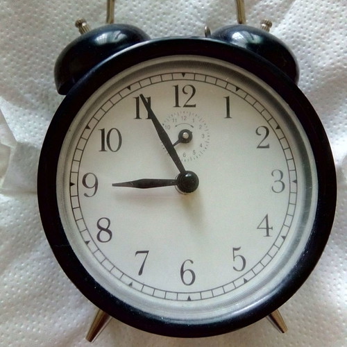 Vintage black wind-up alarm clock, analog, tabletop