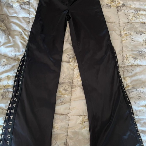New shiny black pants with a design on the side