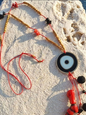 Long necklace with eye pendant coral and lava