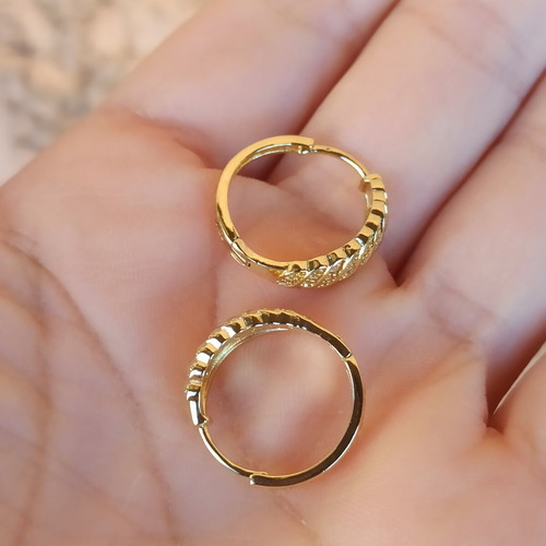 Gold-colored hoop earrings with white zircon stones, copper