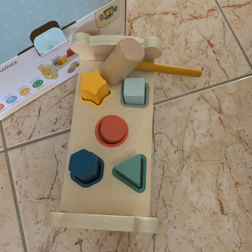 Wooden bench with colorful figures and hammer, like new