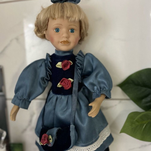 Porcelain doll like new vintage with blue satin dress
