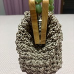 Handmade knitted beige bag with wooden magnetic clasp and beaded handle