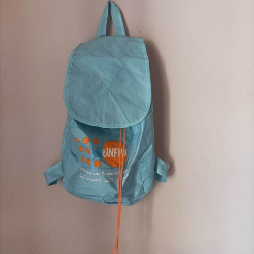 Set of seven multicolor bags including two blue backpacks and one black shoulder bag