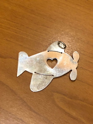 Silver pendant airplane shape with heart detail