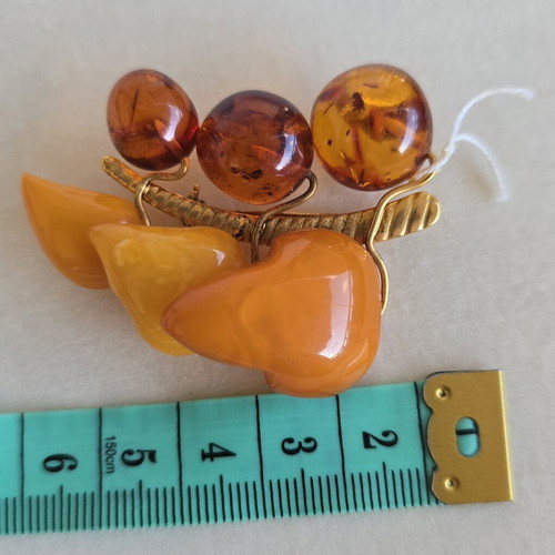 Baltic amber brooch with grape cluster design