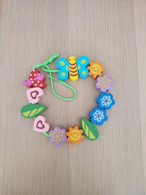 Wooden toy with figures and string used for ages 1.5-4 years