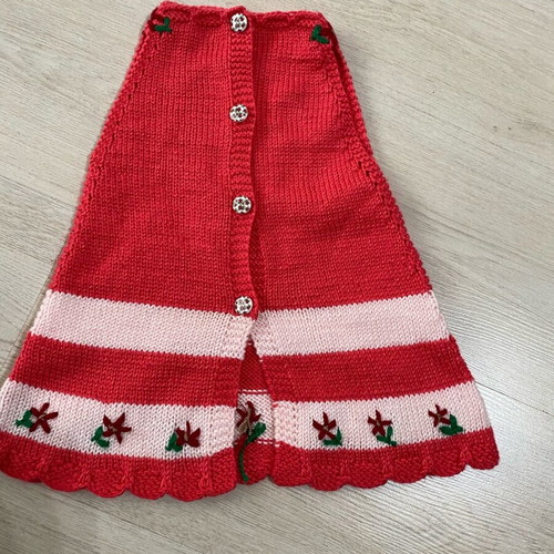 Handmade knitted baby dress in red and pink shades