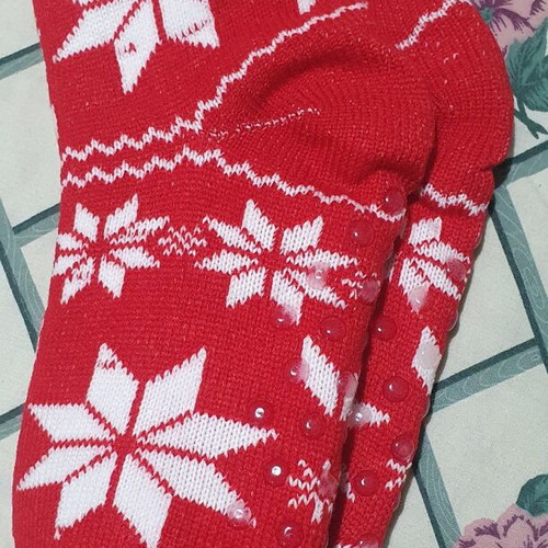 Red knitted slipper socks with white stars and fur lining