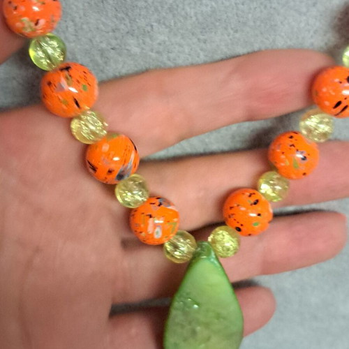 Long necklace with shell pendant, orange and green beads