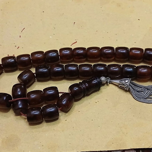 Amber worry beads used with silver elements and tassel