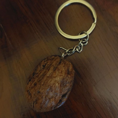 Handmade keychain with natural walnut shell and metal cat