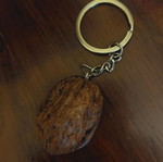 Handmade keychain with natural walnut shell and metal cat