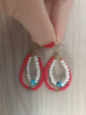 Handmade dangling earrings with red and white beads, turquoise detail