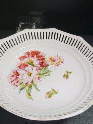 Porcelain deep plate with pierced edge and floral design used
