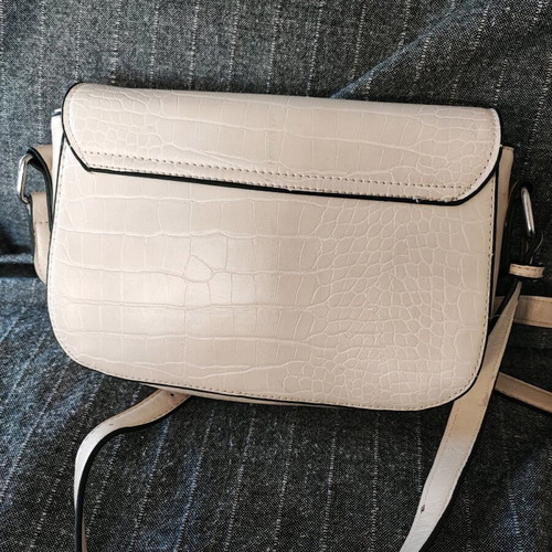 Beige crossbody bag used with adjustable strap