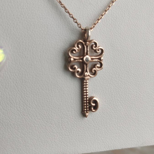 Silver gold-plated key-shaped pendant like new