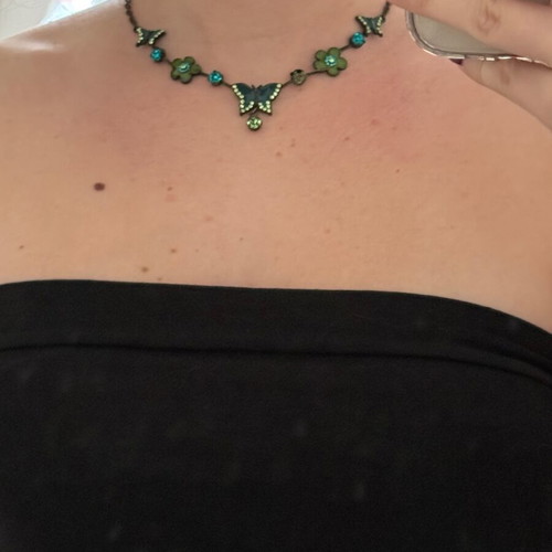 Green necklace used with small butterflies and flowers