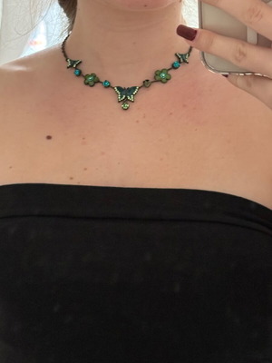 Green necklace used with small butterflies and flowers