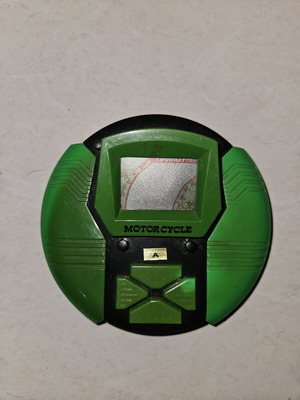 Vintage 1990s handheld LCD electronic game, motorcycle theme