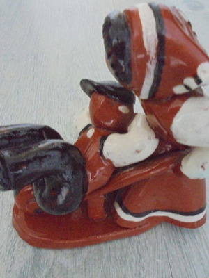 Ceramic figure used, retro genre scene woman pushing man in cart