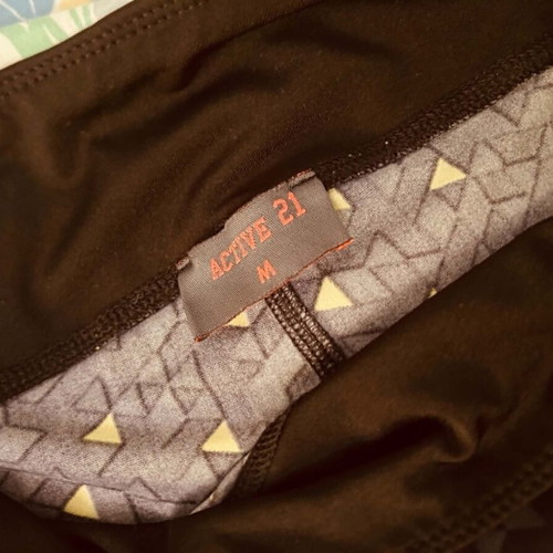 Active 21 black sports leggings with yellow patterns, size M