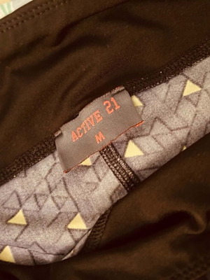 Active 21 black sports leggings with yellow patterns, size M