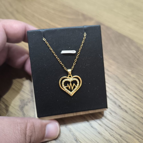 Gold-tone heart necklace with pulse design and sparkling stones