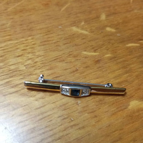 Jewelry pin like new, gold color with blue and clear stones