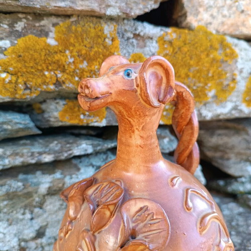 Handmade ceramic jug used with animal-shaped neck and embossed floral designs