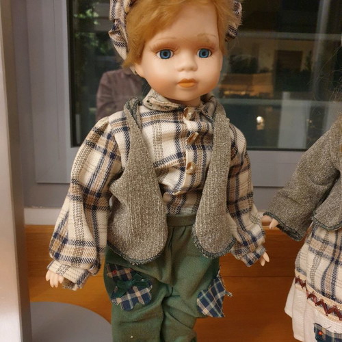 Porcelain dolls new with handmade clothes and support base