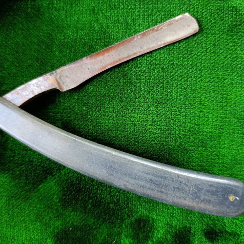 Vintage straight razors with leather strop and wooden handle