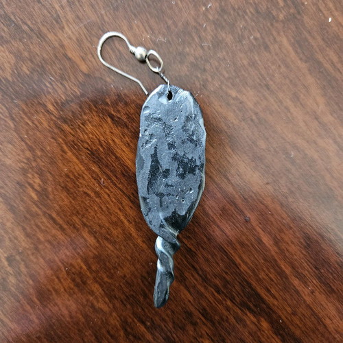 Black earring used, totem-inspired with multicolor pattern
