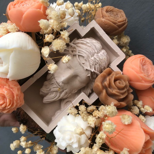 Handmade arrangement with scented candles and embossed Christ figure