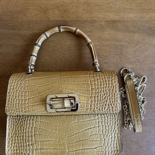 Yellow leather bag with bamboo strap