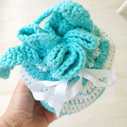 Handmade turquoise knitted pouch toiletry bag used
