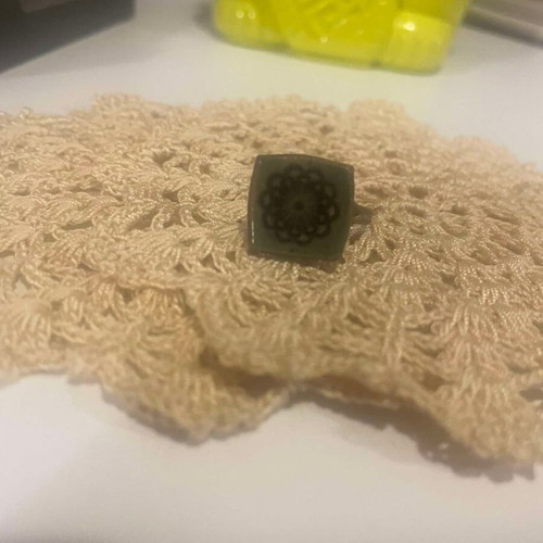 Metal ring used with adjustable green ceramic flower