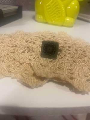 Metal ring used with adjustable green ceramic flower