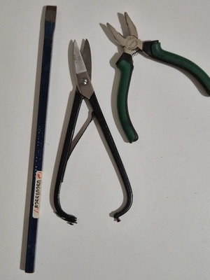Cutting tool, small pliers and metal chisel used