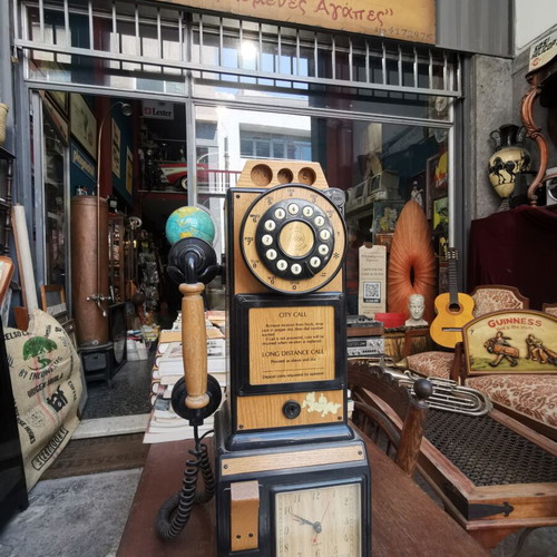 Vintage decorative wall telephone with clock used