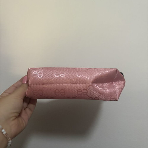 Pink toiletry bag like new with all-over logo pattern