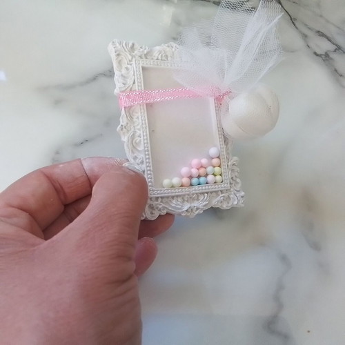 Vintage plaster frame with perfume bottle