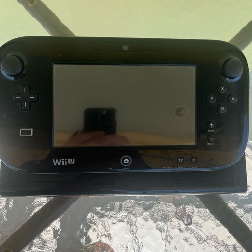 Nintendo Wii U console used with game cartridges and cables