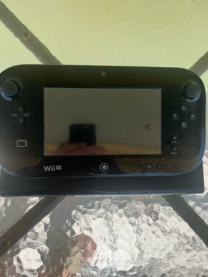 Nintendo Wii U console used with game cartridges and cables