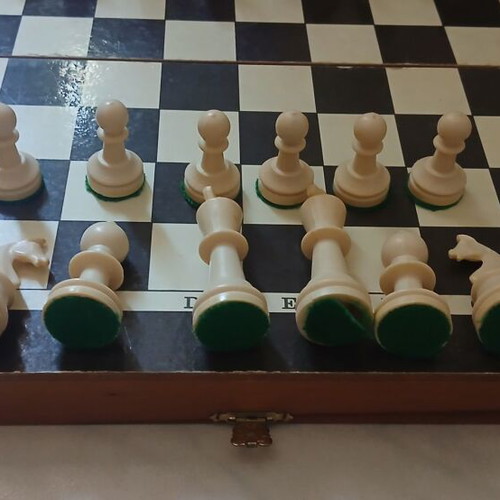 Chessboard with pieces and backgammon