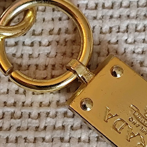 Authentic Prada gold key ring unisex like new