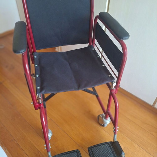 Transport wheelchair with metal frame and brakes